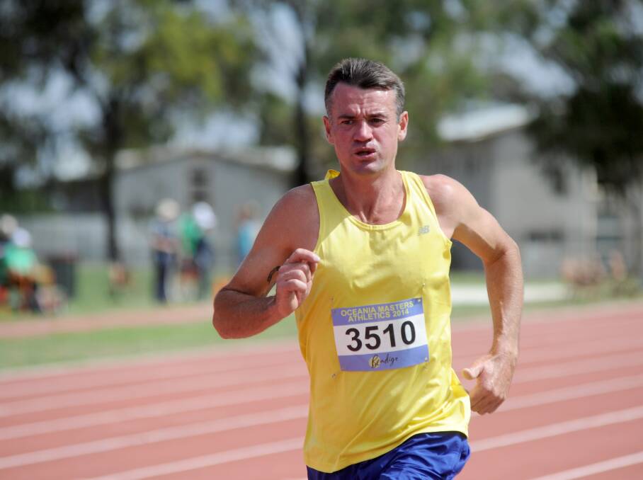 HOME TRACK: Bendigo's Darren Hartland races to the finish of the 35-39 years 5000m.