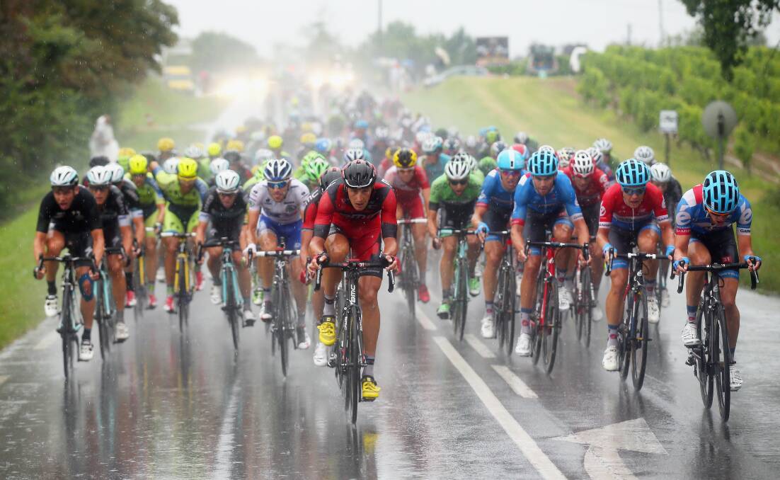 Riders race through the rain in Friday's 19th stage of the Tour de France. Picture: GETTY 