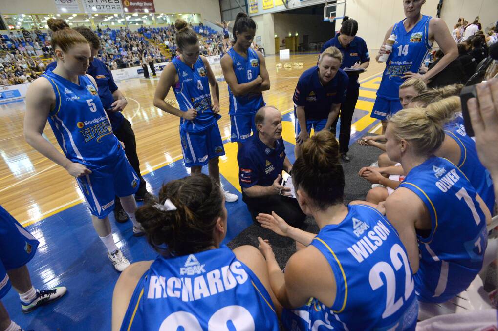 Bendigo Spirit coach Bernie Harrower urges the players on during a time-out in the home-court win against Logan Thunder. 