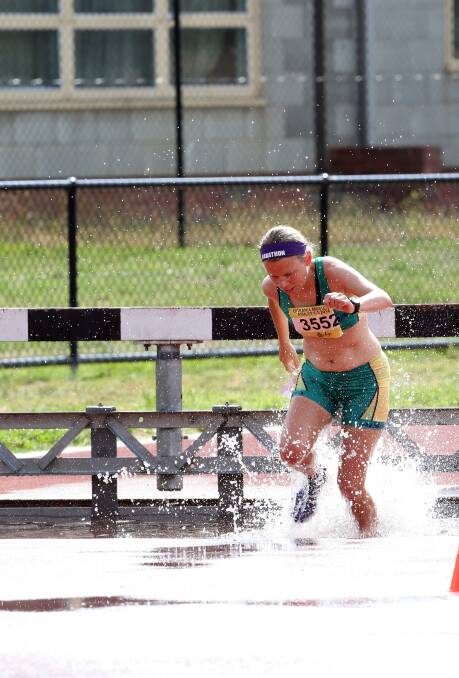Lisa Davis charges through the water hazard in the steeplechase. Picture: LIZ FLEMING 