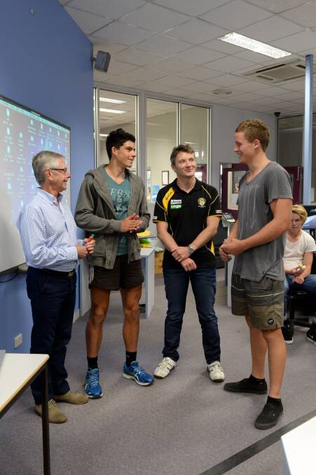 HANDY HINTS: Kim Stephens and Richard Taylor from Richmond Football Club talk to young footballers Sam Harper and Jake Maher at BSSC. Picture: JIM ALDERSEY
