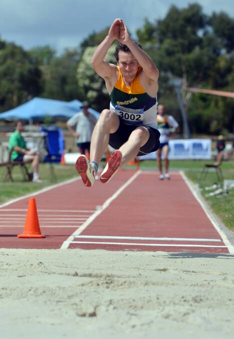 BIG LEAP: Mathew Brooks contests the long jump leg in the 30-34 years decathlon. Picture: BRENDAN McCARTHY
