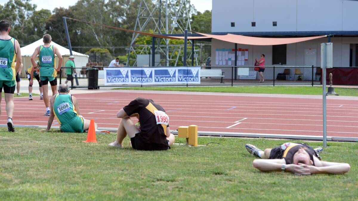 EXHAUSTED: Athletes take a well-earned rest after the 1500m leg of the decathlon. Picture: LIZ FLEMING 