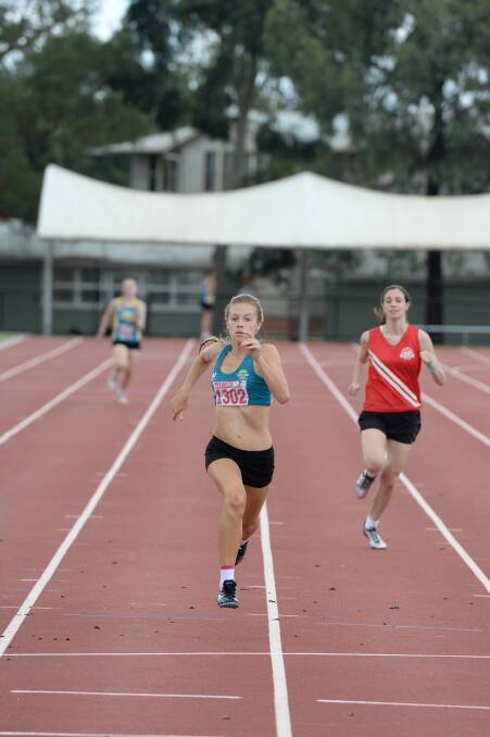 Kate Salvador from Bendigo Harriers sprints to victory in the 300m as Stephanie Pompeti fights on to be third. 