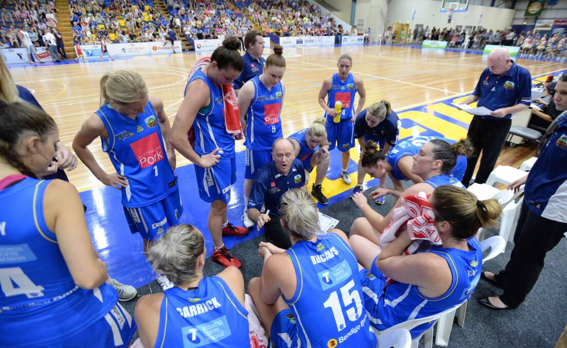 TIGHT-KNIT: Bernie Harrower talks tactics during a time-out in Bendigo Spirit's home-court clash with Townsville Fire. 