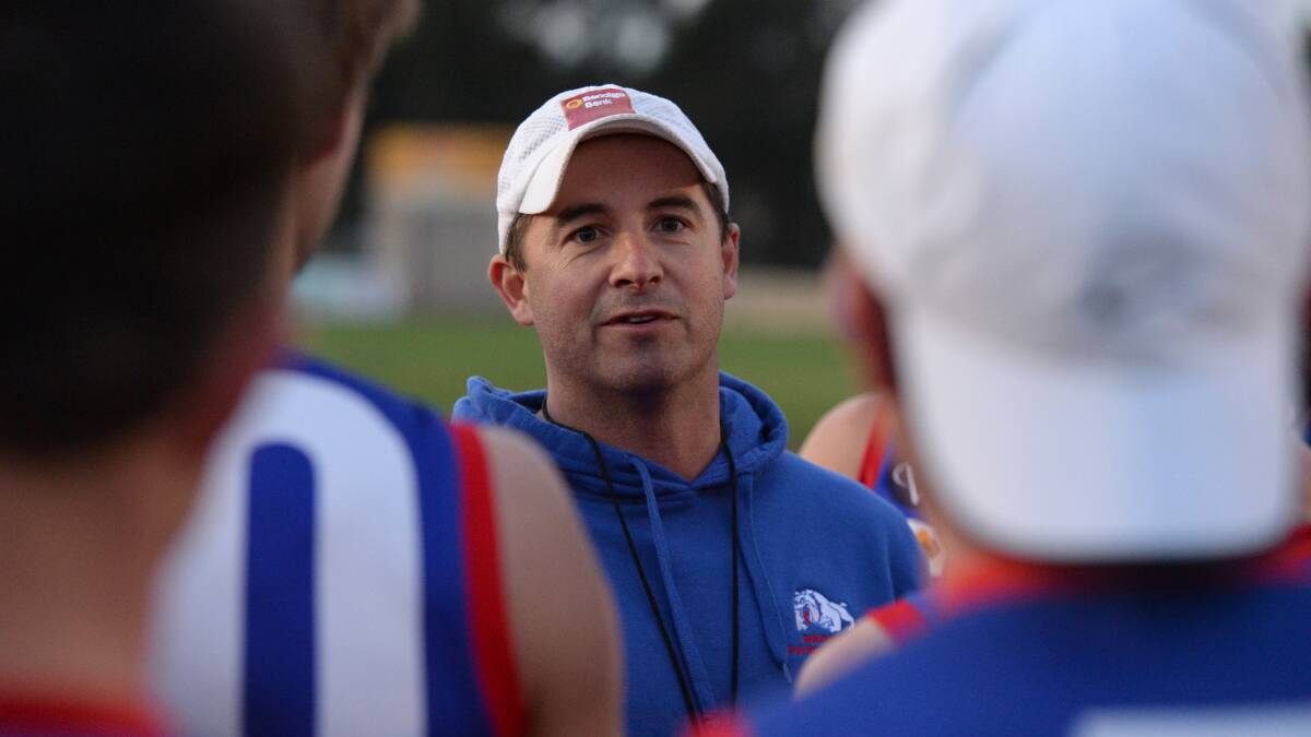 STEELY INTENT: North Bendigo co-coach Rob Bennett speaks to the players before Thursday night's training run at Superior Roofing Oval. Picture: JIM ALDERSEY