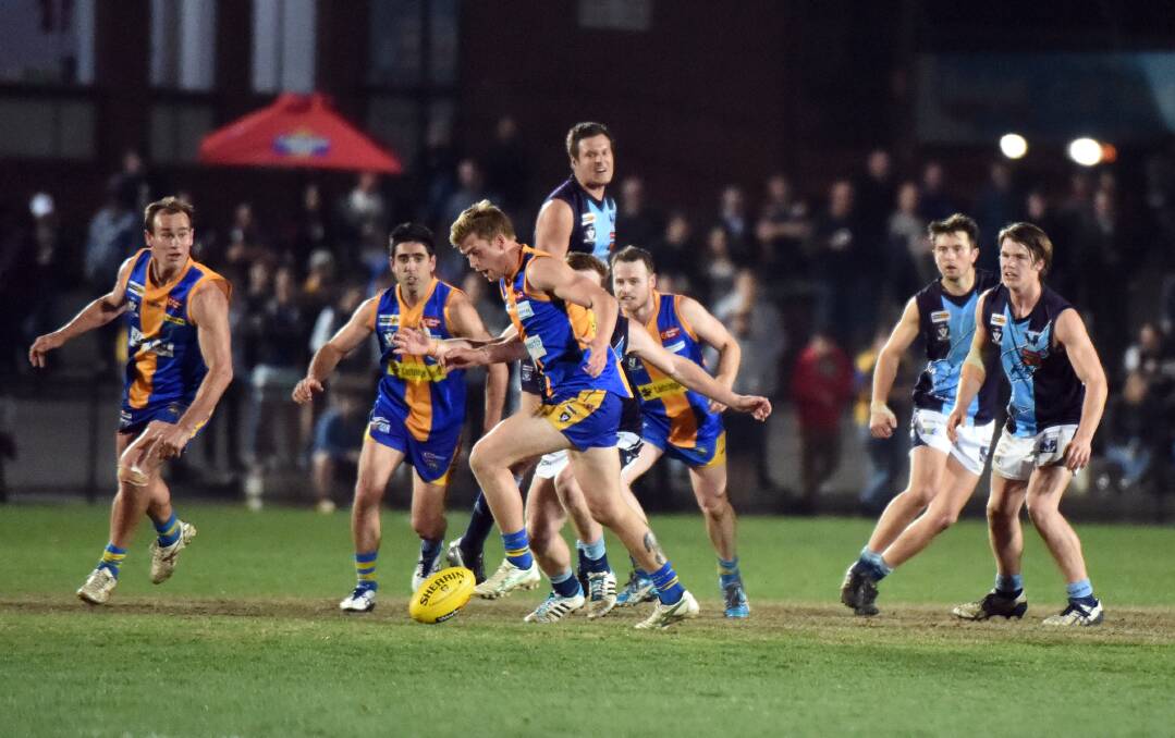CLEARANCE: Golden Square's Che Walls leads the race for the footy from this centre contest against Eaglehawk in the seniors elimination final. Pictures: LIZ FLEMING