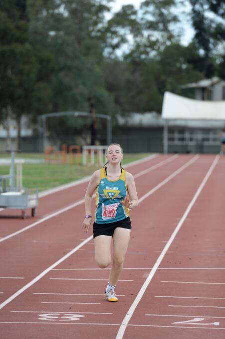 Chloe Green from Bendigo Harriers races to the line in the women's 300m. 