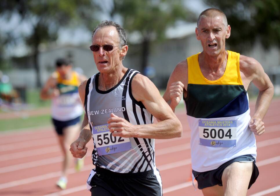 DUEL: New Zealand's Ian Calder leads Bendigo's Peter Cowell in the 5000m race around the Flora Hill track. 