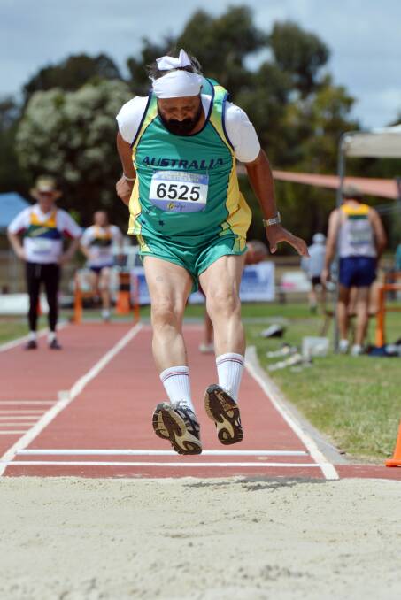 FOCUSED: Raminder Singh leaps in the long jump leg of the 65-59 years decathlon on the opening day of the Oceania Masters athletics championships in Bendigo. Picture: BRENDAN McCARTHY 