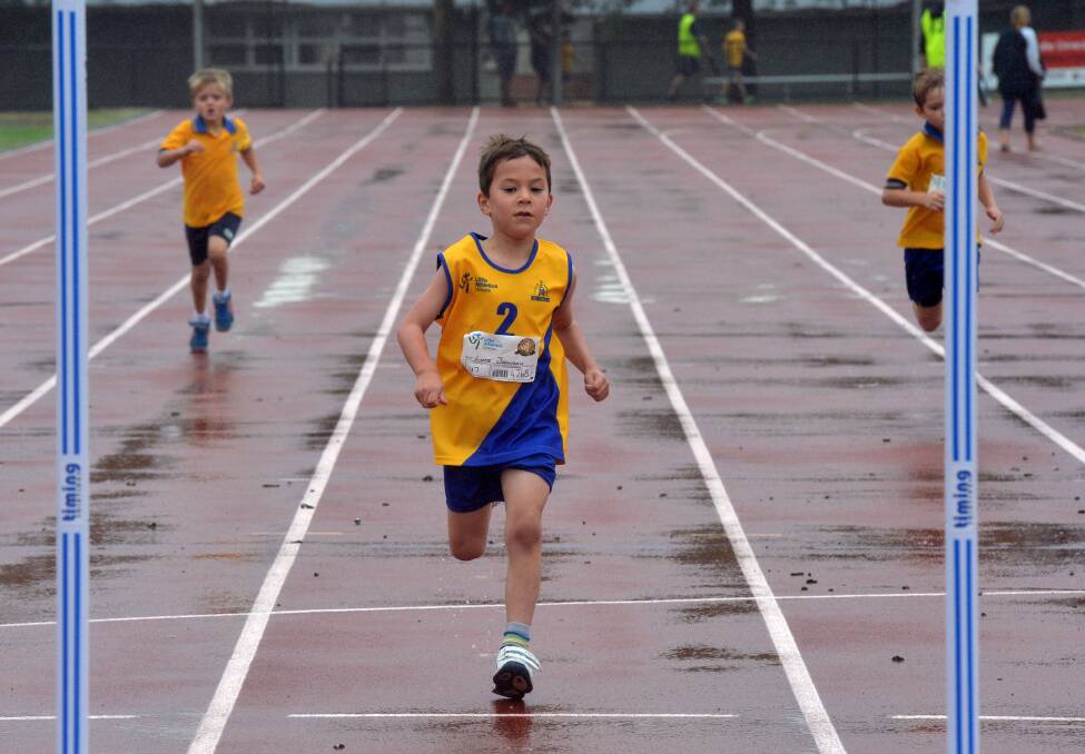 Luke Johnson races to the finish in a 200m heat for the under-7 boys. 