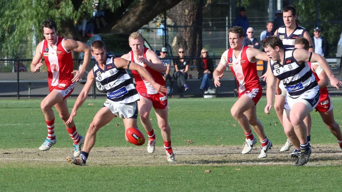 CENTRE CLEARANCE: Storm's Matthew Ladson leads the race for the footy on Queen Elizabeth Oval. Picture: PETER WEAVING 