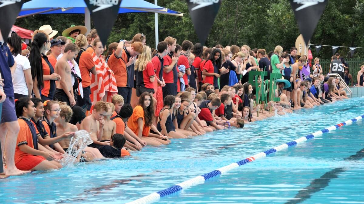 Students eagerly await the announcement of the age group, Spirit Cup and overall house champions at Girton Grammar's swimming carnival. 
