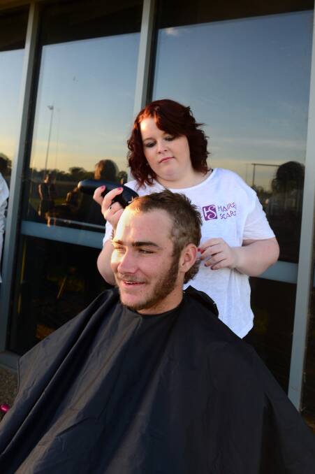 IN THE CHAIR: Cameron Barrett has his hair shaved by Samantha Coughlin from Hairem Scarem. Picture: JIM ALDERSEY