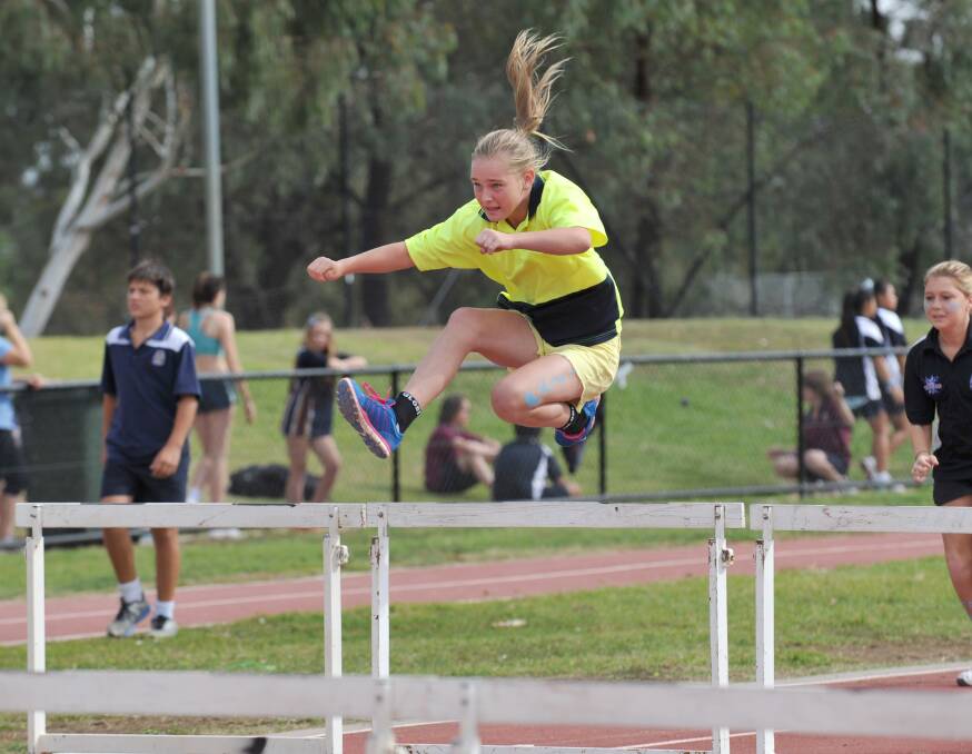 GREAT FORM: Brooke Tecklenburg from Merin house competes in the hurdles at Weeroona College's track and field championships. Picture: JODIE DONNELLAN 