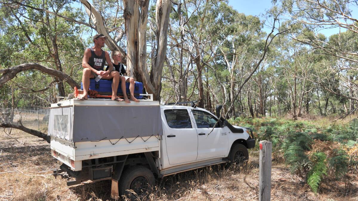 VANTAGE POINT: Shane and Mitch Toy have a great view of the tour on Mount Alexander. Picture: JIM ALDERSEY