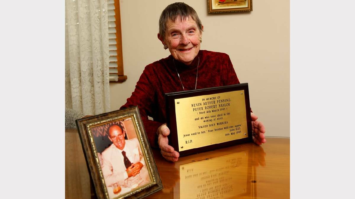 Beryl Fenning holds her late husband’s memorial plaque. Crane driver Kevin Fenning died in 1995. Picture: Jonathan Carroll