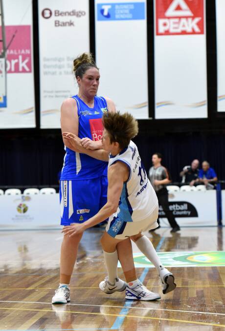 Canberra Capital Jessica Bibby runs into a strong Gabe Richards screen. Picture: BILL CONROY