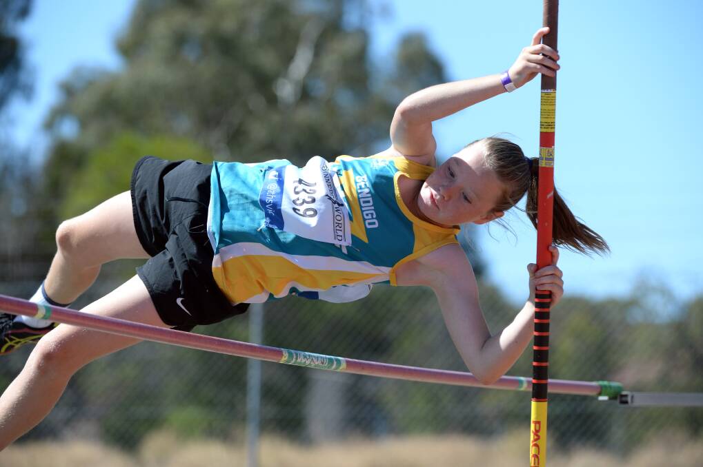 UP AND OVER: Eleven-year-old Emma Gilligan on her way to a personal best of 2.30m in the pole vault. Picture: GLENN DANIELS