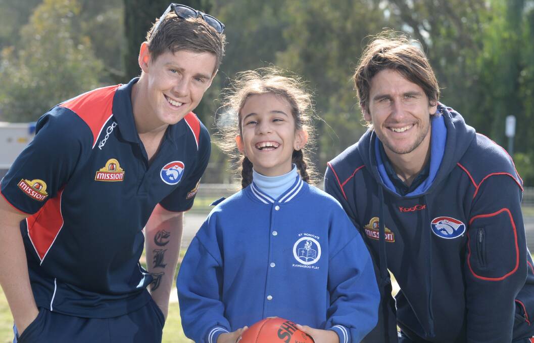GOOD SPORTS: Western Bulldogs players Sam Darley and Ryan Griffen meet Ella Edwards at St Monica's.

RIGHT: Student Dylan Barry takes part in the footy clinic. Pictures: JIM ALDERSEY