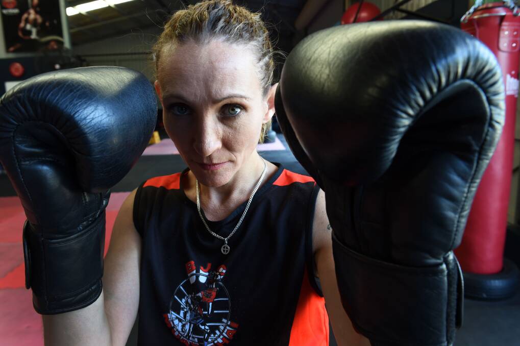 GLOVES ON: Martial arts instructor Kelly Warren holds a second degree black ranking in muay thai and is also a black belt in karate. Picture: BRENDAN McCARTHY