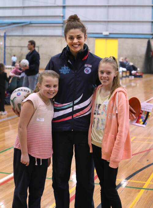 Watson meets young netball fans Olivia Nihill and Imogen Yeates at a clinic in Bendigo. Picture: PETER WEAVING
