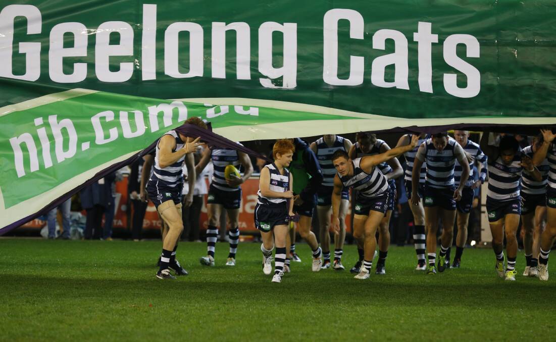 Selwood clears the way for young Col to lead the team on their warm-up lap. Picture: AFL