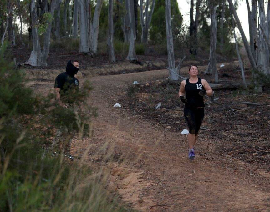 Tegan runs in bushland near the AIS in Canberra as part of the boot camp exercise.