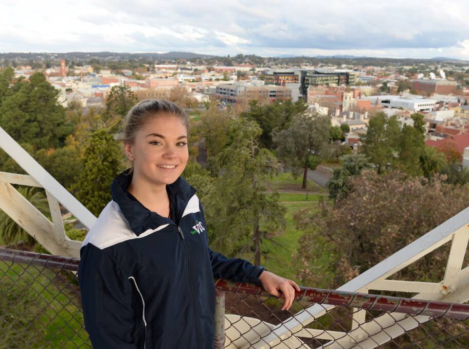 TALL ORDER: Bendigo diver Megan George has no fear of heights, whether she's climbing the poppet head in Rosalind Park or plunging into the pool from the platform. Picture: JIM ALDERSEY 