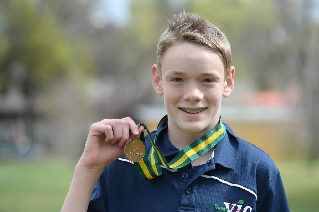 Liam shows his latest gold medal, from the School Sport Australia cross country championships.