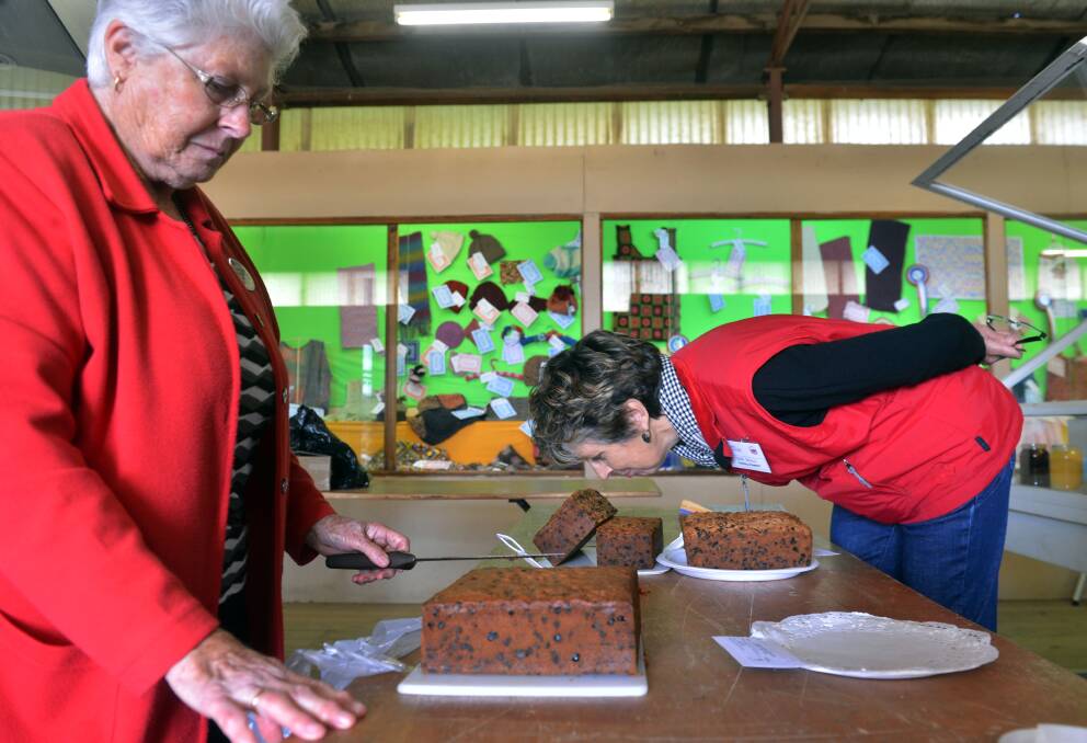 During preparations for the Bendigo Show CWA Judge June Milgate and Cooking Steward Jan Doyle judging the fruitcake category.  Picture: BRENDAN McCARTHY