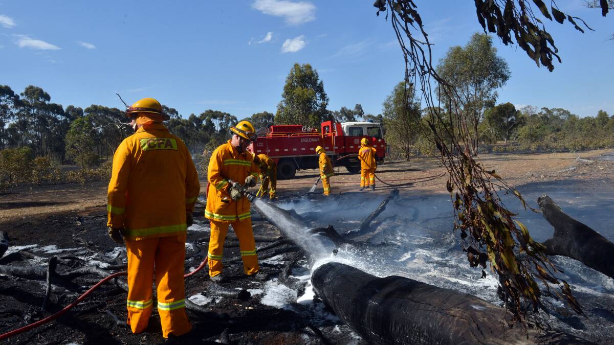CFA crews mop up after a grass and scrub fire of Millers Flat Road in the Whipstick State Forest.
Picture: BRENDAN McCARTHY