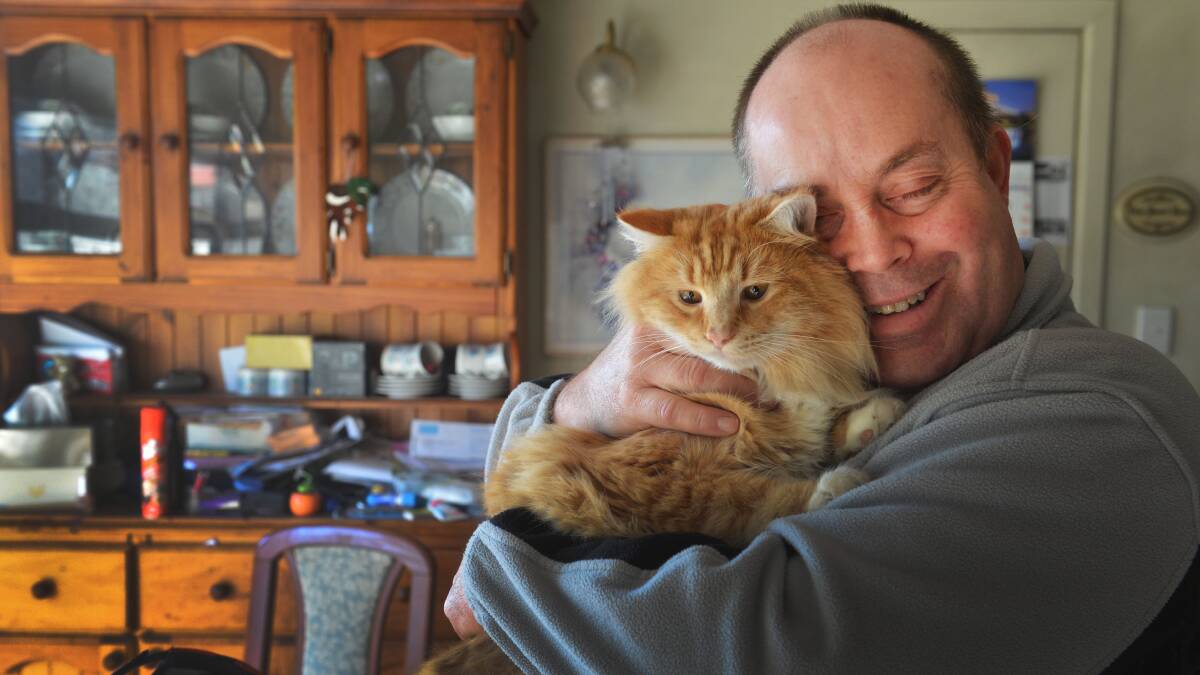 Ken Scott thanks Garfield the cat for alerting him to a potentially dangerous gas leak Picture: Brendan McCarthy