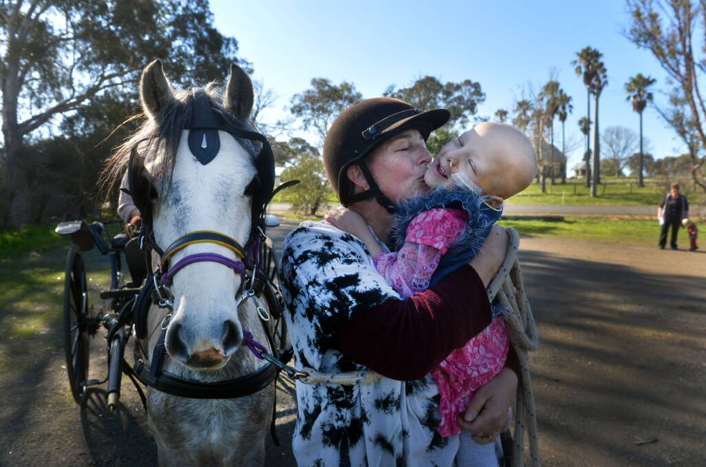 Mum Karina Pickrill introduces Abigail 4, a cancer patient, to her new Pony, Hope, a gift from the local community.  Photo: Brendan McCarthy 