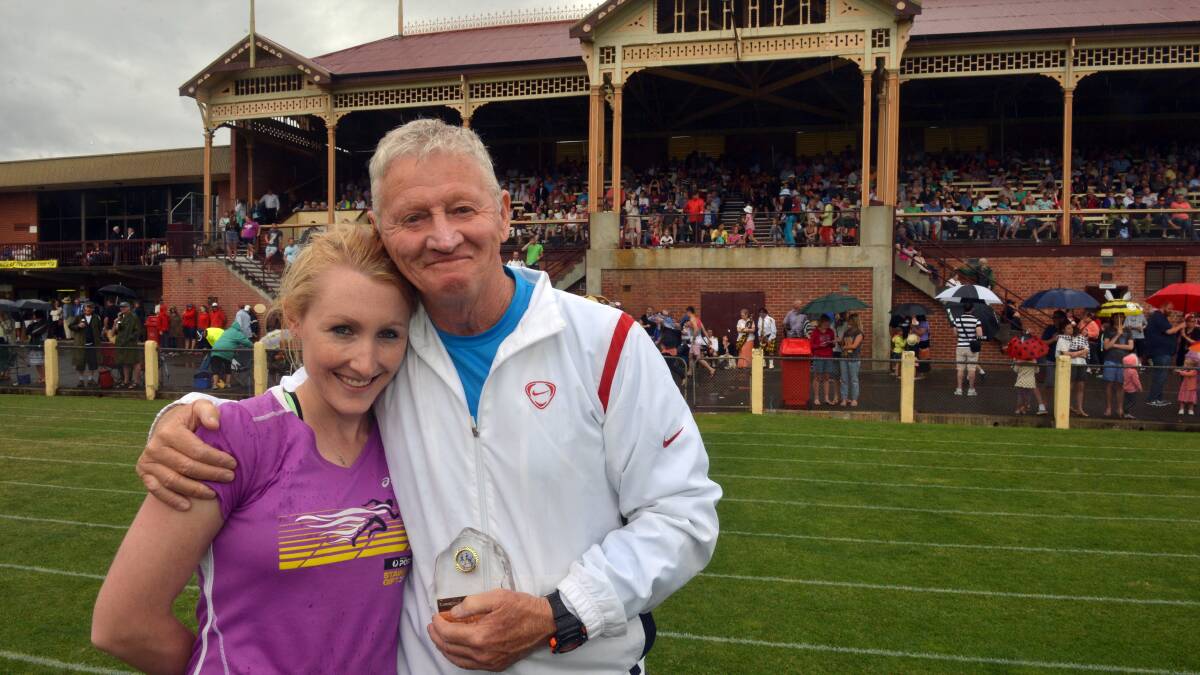 Athlete Danielle McDowell congratulates her coach Terry McGarity on his award for 14 years of race calling.
Picture: BRENDAN McCARTHY