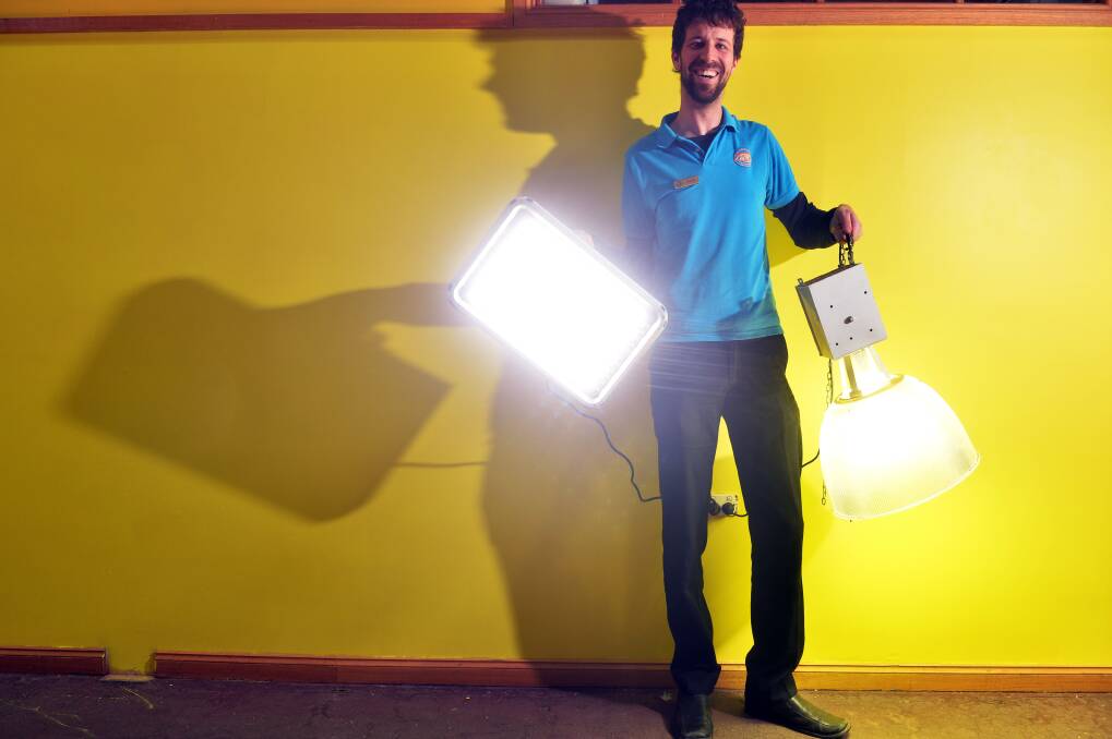 David Holmes, Mgr of Bendigo Discovery Science & Technology Ctr with 1of the newly installed 120 w LED lights (left) & 1 of the older 500w Bay Lights that have been replaced
Picture: BRENDAN McCARTHY
