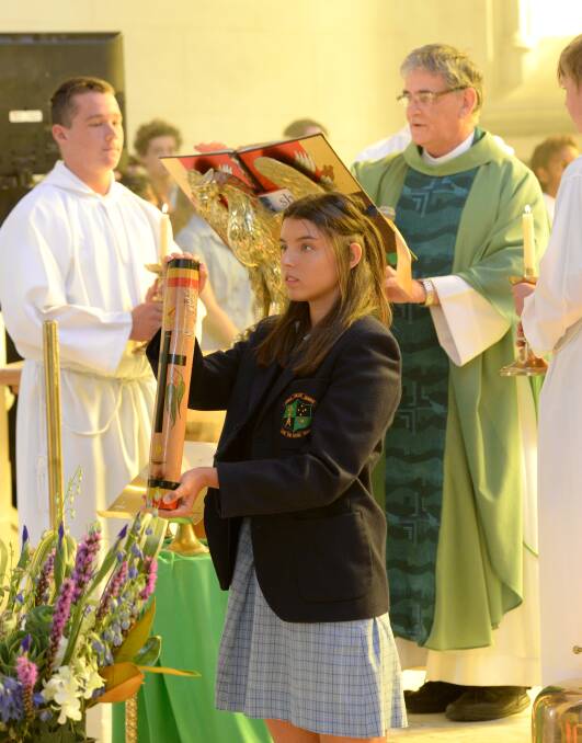 ASSIST: Students played an important role in the opening mass. Pictures: JIM ALDERSEY