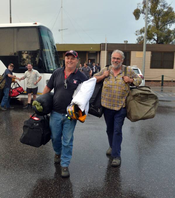 HAPPY: Neville Winther and Ken Butler get off the bus in Bendigo with their gear. Pictures: BRENDAN McCARTHY
