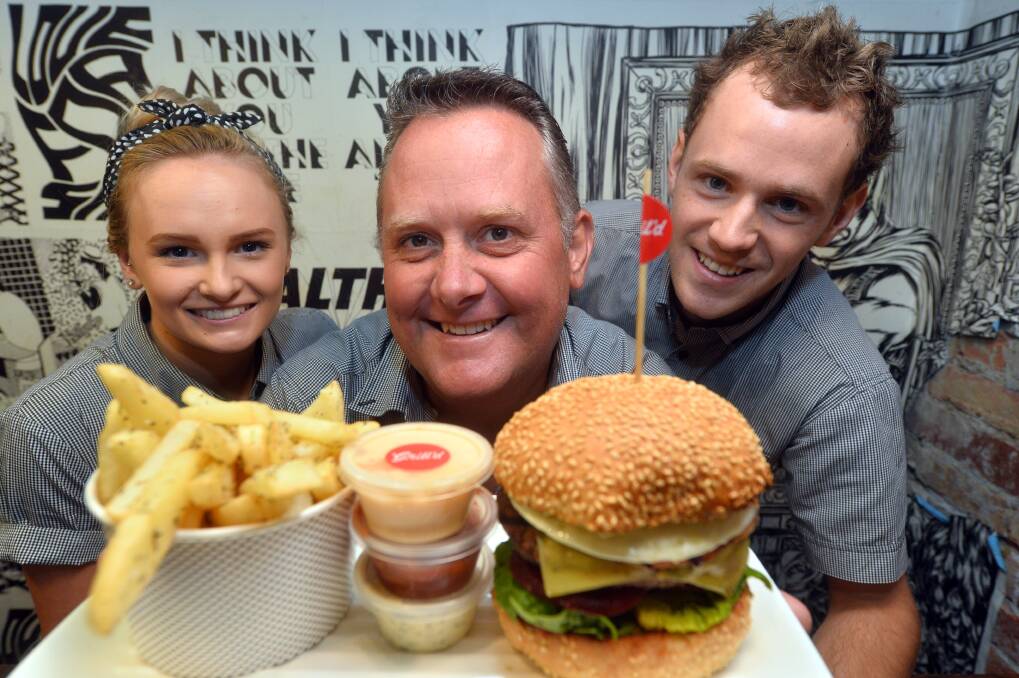 Grill'd staff Dayna Northrope, owner Richard Nash and Ryan Holt. Picture: BRENDAN McCARTHY