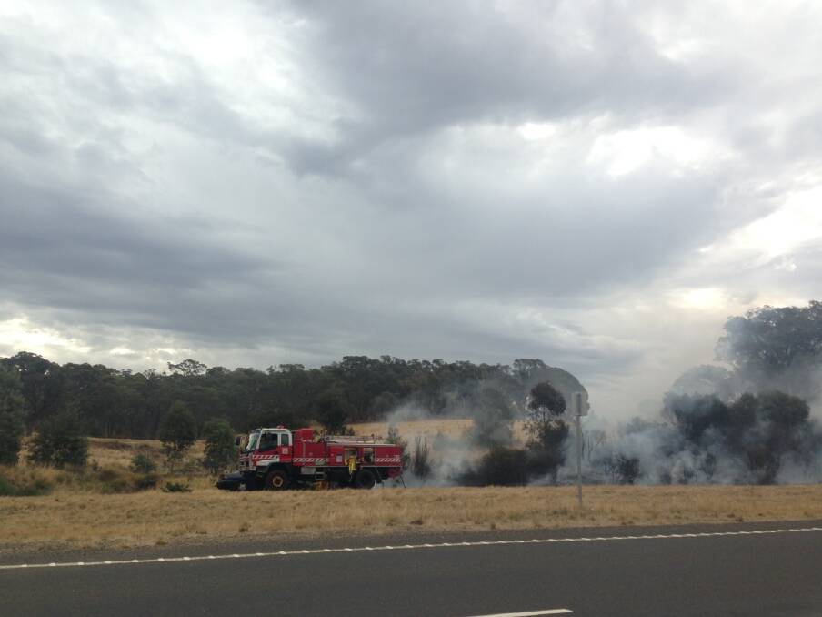 CFA crews work to extinguish the grassfire. 