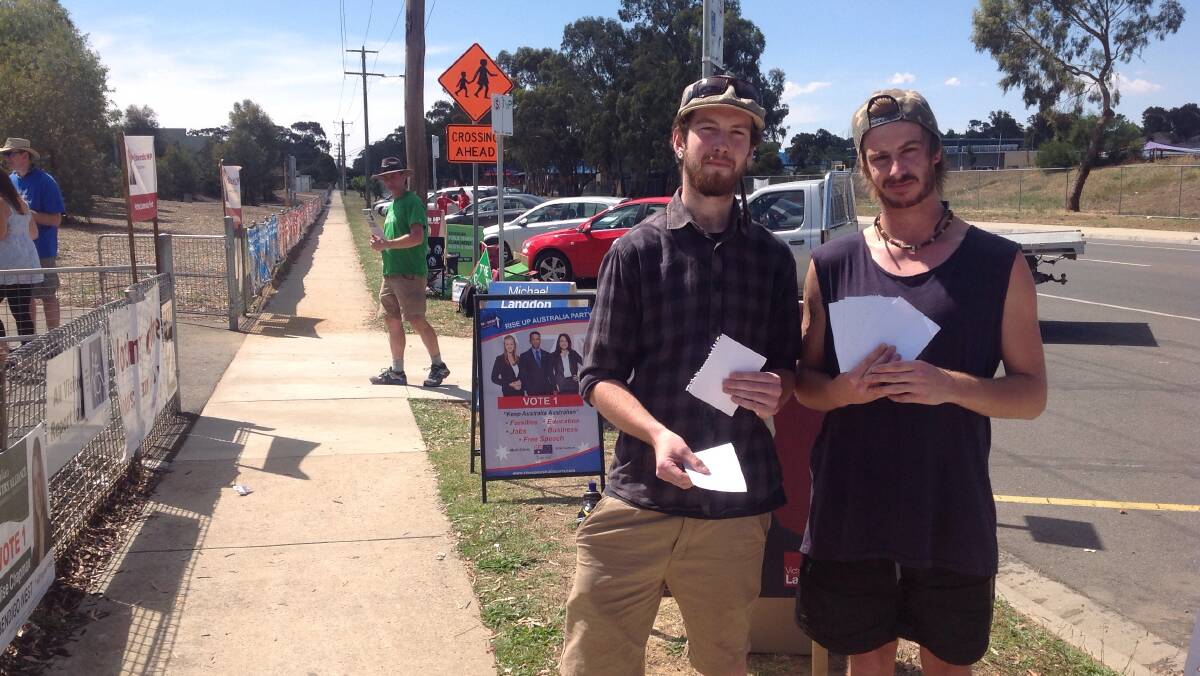 THINK ABOUT IT: Jacob Shanahan and Brenton Patty hand out blank pieces of paper at Crusoe College as their own protest against the election.