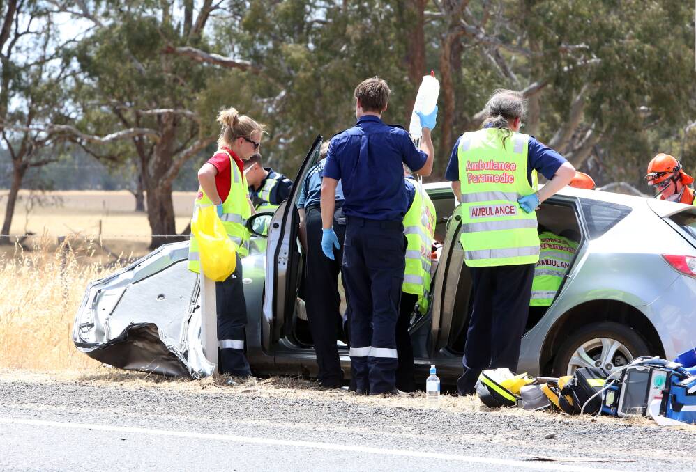 TRAPPED: Emergency crews attended to an older driver after he collided with a truck. Picture: LIZ FLEMING 