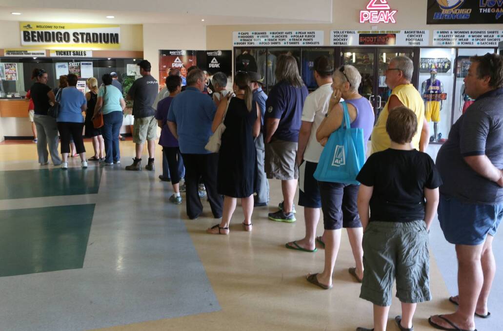 People line up at Bendigo Stadium to buy tickets. Picture: PETER WEAVING