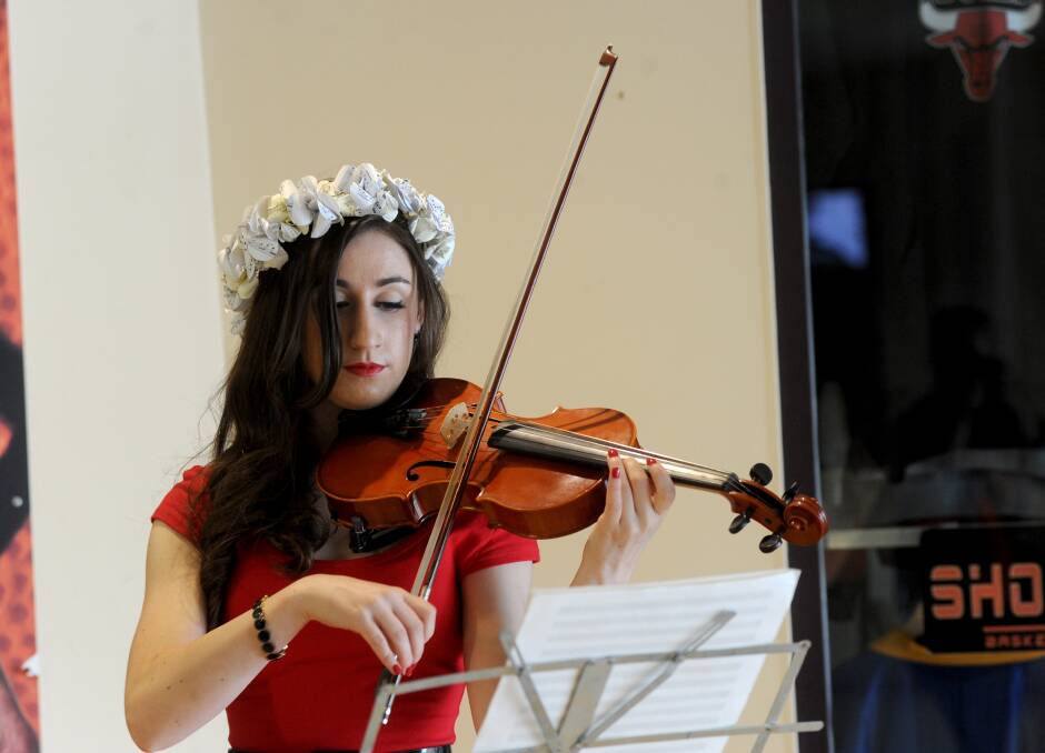 Evangeline Victoria played her violin as guests walked in. Picture: JODIE DONNELLAN 
