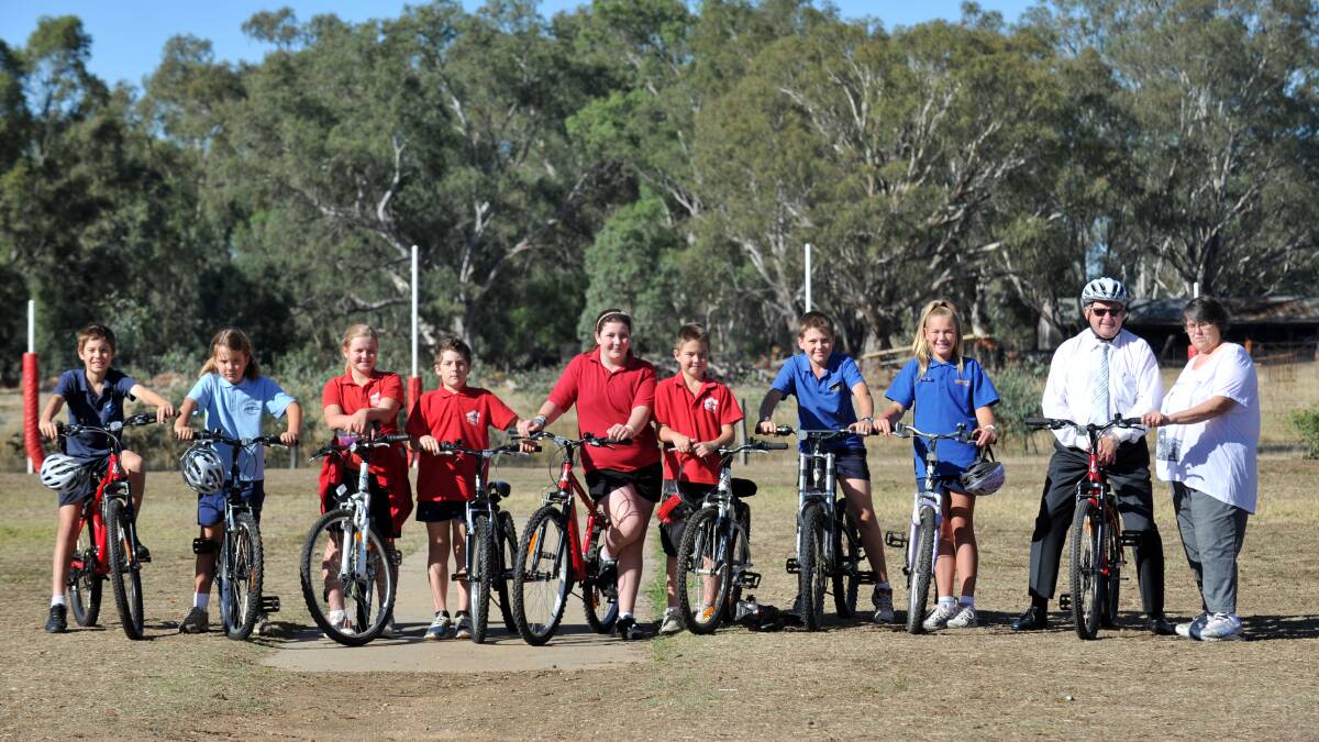Leonie Francis from Bendigo Northern District Community Enterprise, White Hills students Liam and Sarah Morse-McNabb, Epsom students Asher Geddes, Seeton Bertuch, Cassie Jones and Broden Plowright and Huntly students Waylon Draper and Abbey Hromenko with Mayor Barry Lyons (on bike). 

(Bendigo Northern District Community Enterprise donated the pedometers) Picture: JODIE DONNELLAN