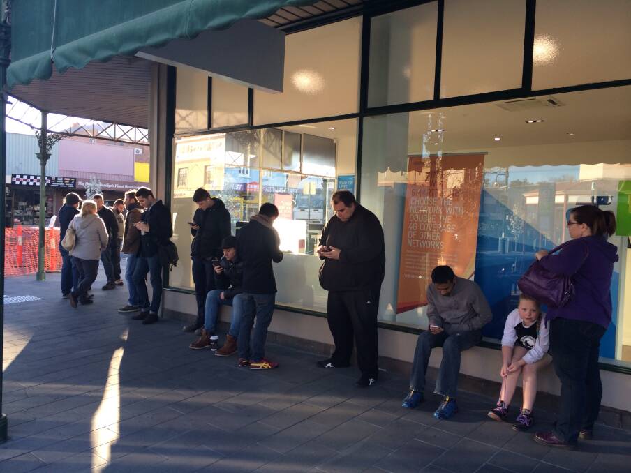 A line has formed out the front of the Mitchell Street Telstra store. 