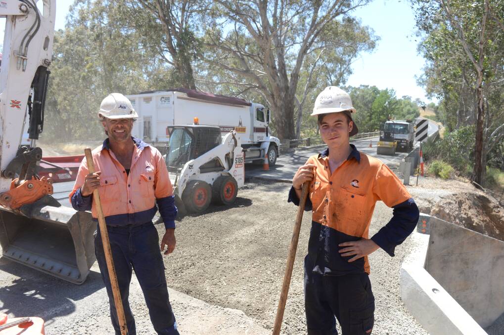 Thommo and Darcy Hayen working on the road just outside of Axedale is hot work on a Summer's day. Picture: JIM ALDERSEY
