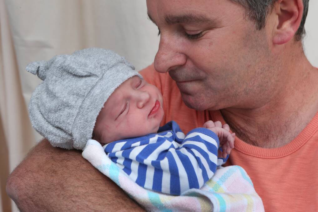 HELLO WORLD: Peter Anderson holds his son Jack who was born at 7.48am on New Year's Day. Picture: PETER WEAVING 