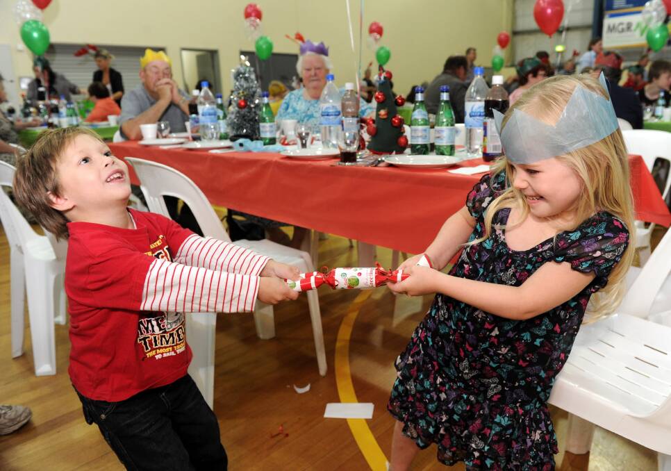 FUN: Tyson Hansford and Madison Hicks crack a bonbon at the lunch. Pictures: JODIE DONNELLAN 
