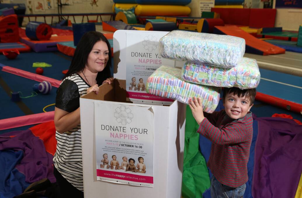THANKS: Tasman, 4, and Emma Clohesy donate some nappies. Picture: PETER WEAVING